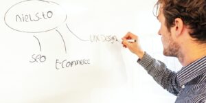 a man writing on a whiteboard